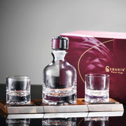 a bottle and two glasses sitting on a table