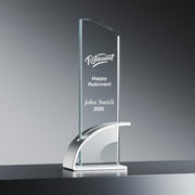 a clear glass trophy with a curved base