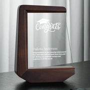 a glass plaque with a wooden frame on a table
