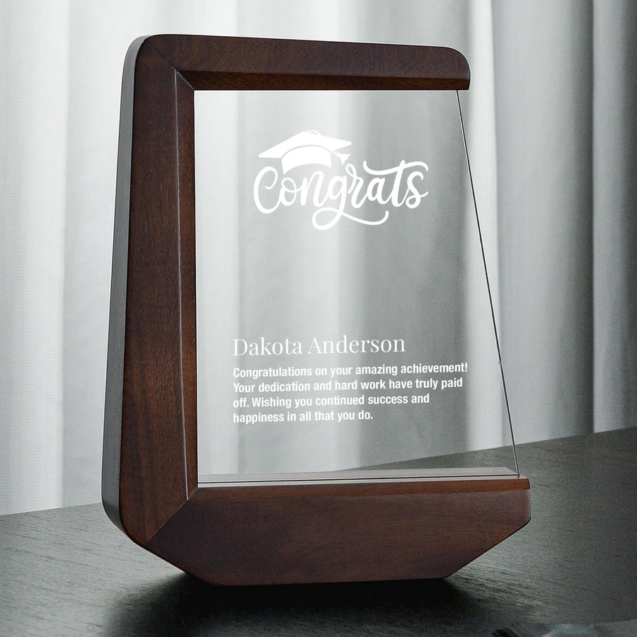 a glass plaque with a wooden frame on a table