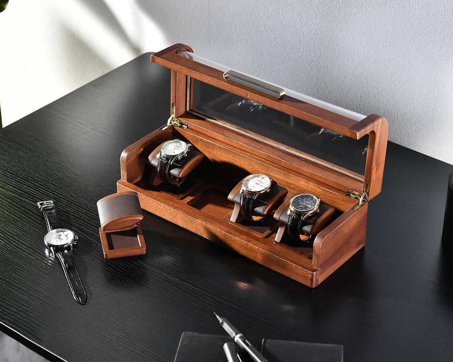 a wooden watch box with three watches in it