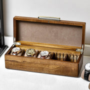 a wooden box with four watches inside of it