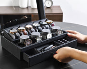 a person holding a watch in a black box