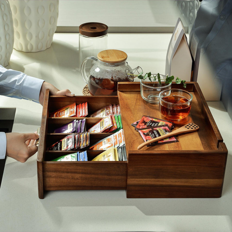 a person is holding a tray with a variety of teas