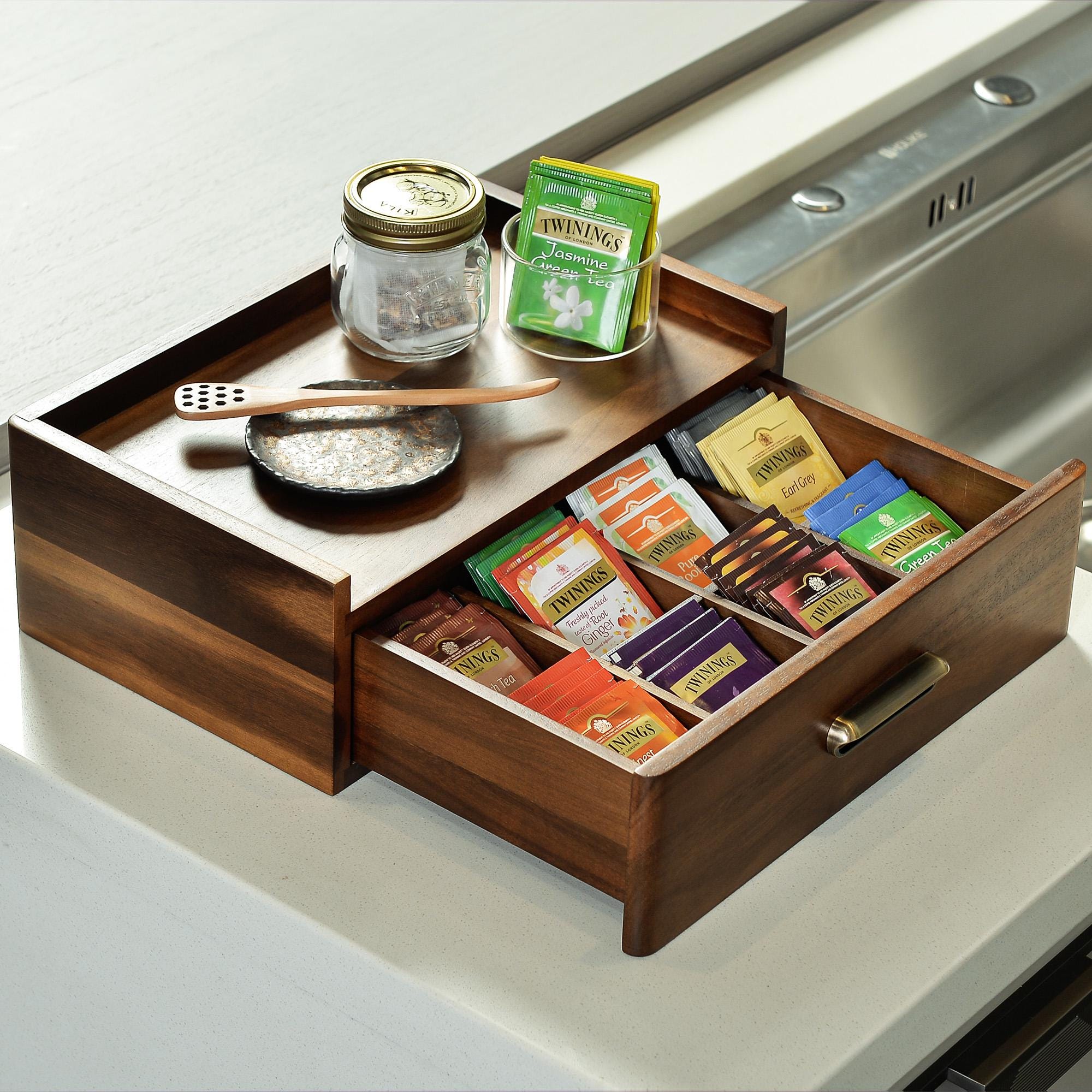 a kitchen counter with a spice box and utensils