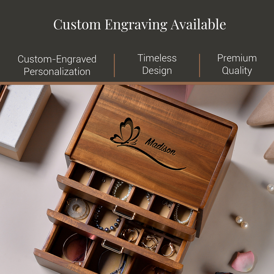 A wooden jewelry box with a butterfly design, displaying various pieces of jewelry inside. The box has a label that reads "Madison".
