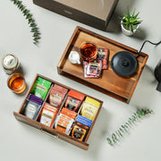 a box of tea and a cup of tea on a table