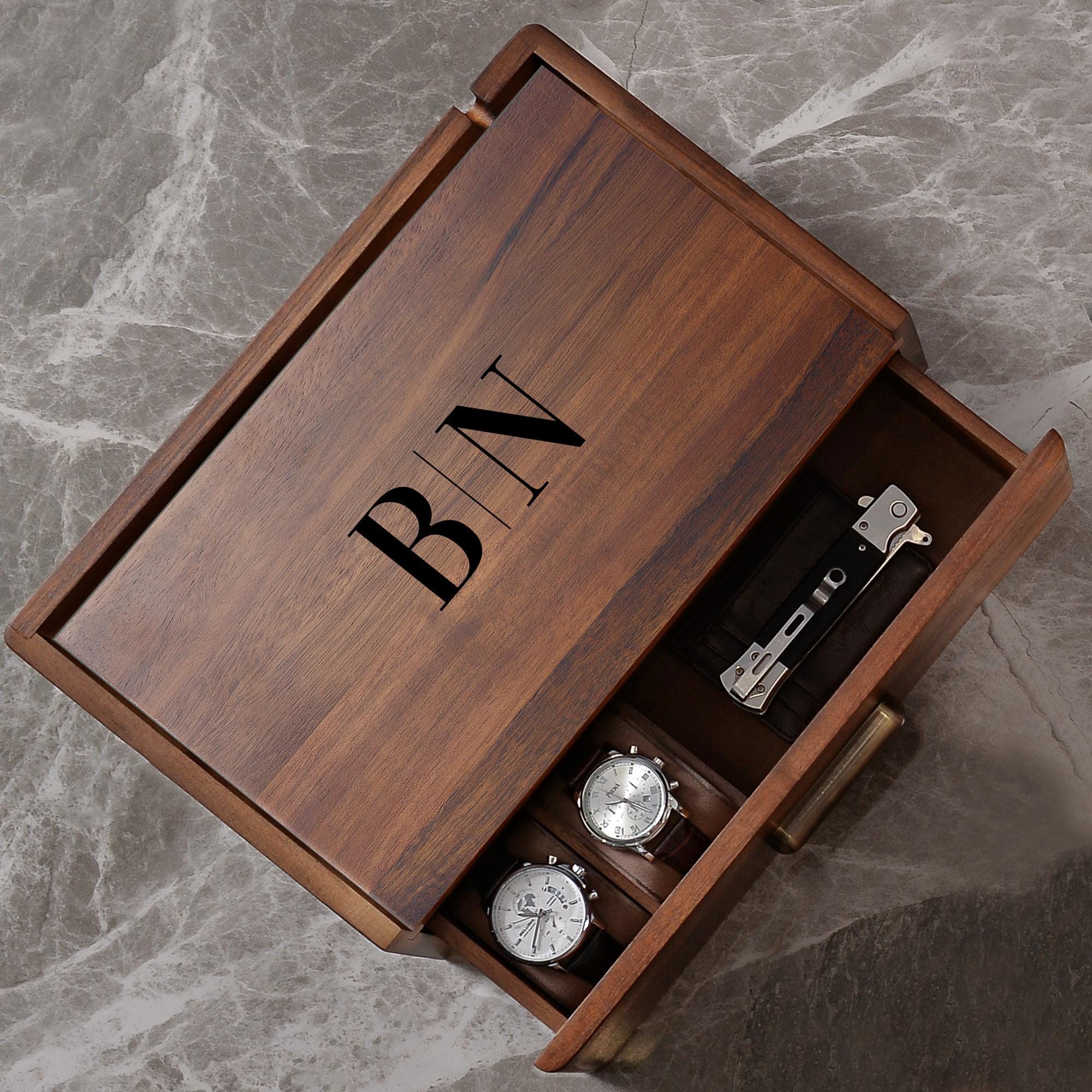 a wooden box with a watch inside of it