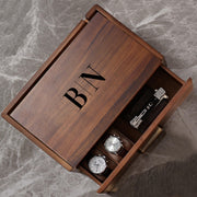 a wooden box with a watch inside of it