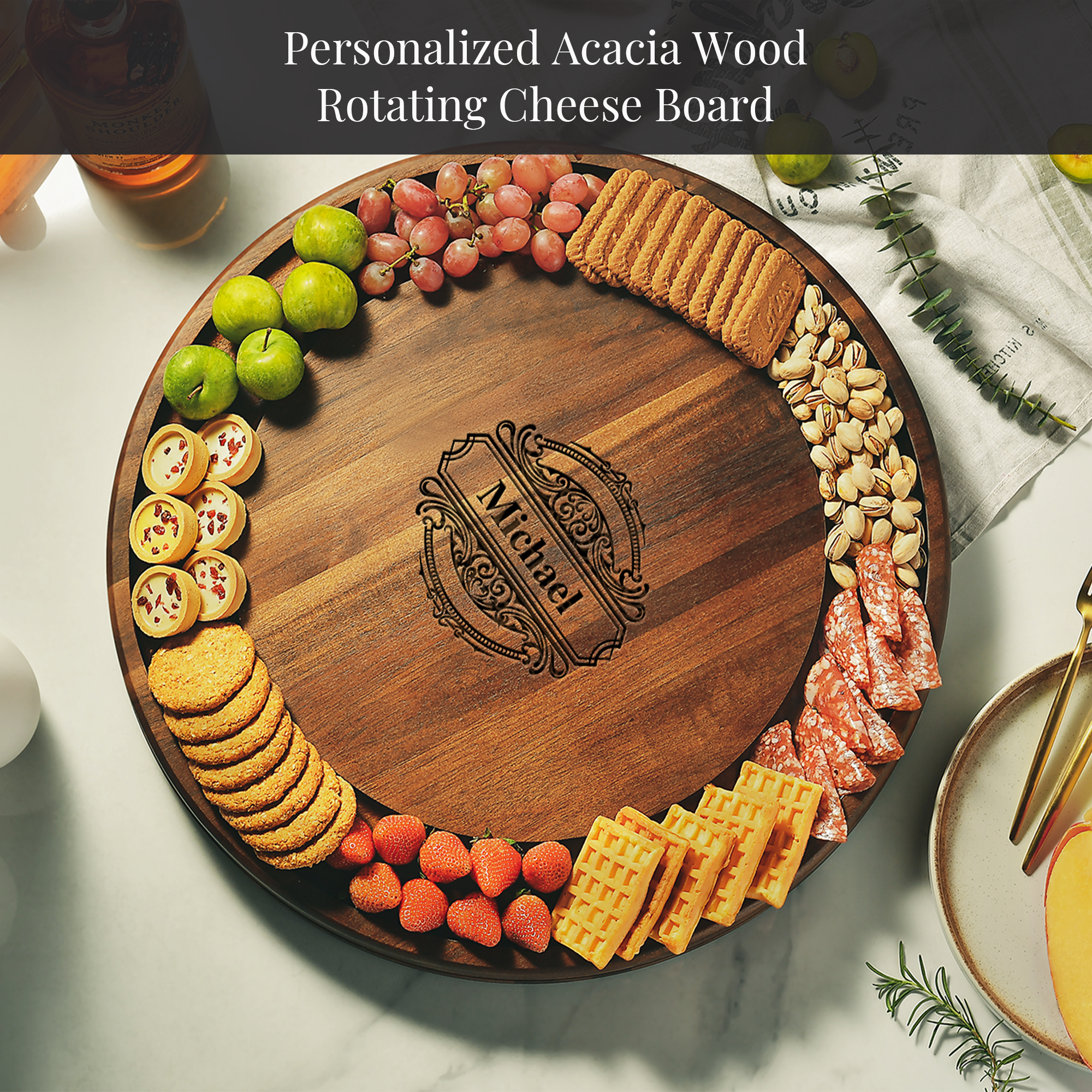A wooden serving platter with various snacks and cheeses arranged on it, featuring a personalized name carved into the center.