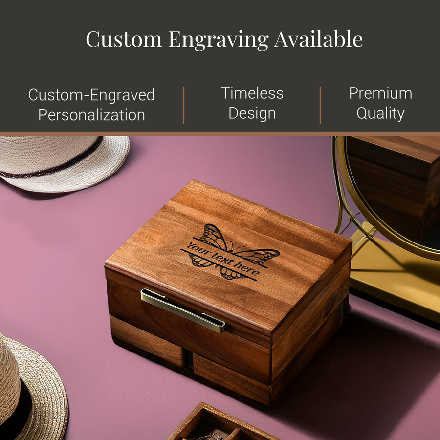 a wooden box with a butterfly design, placed on a pink surface. The box has a handle on the front and appears to be a custom-engraved wooden box.