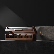 a wooden box with a set of five knives in it