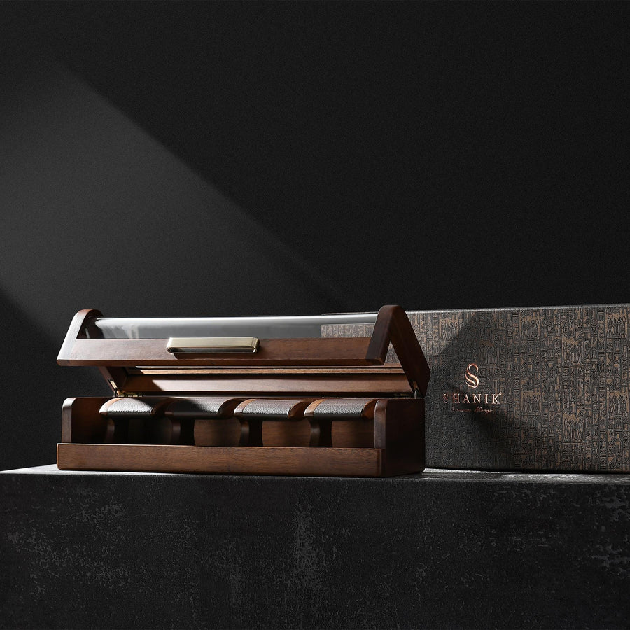a wooden box with a set of five knives in it