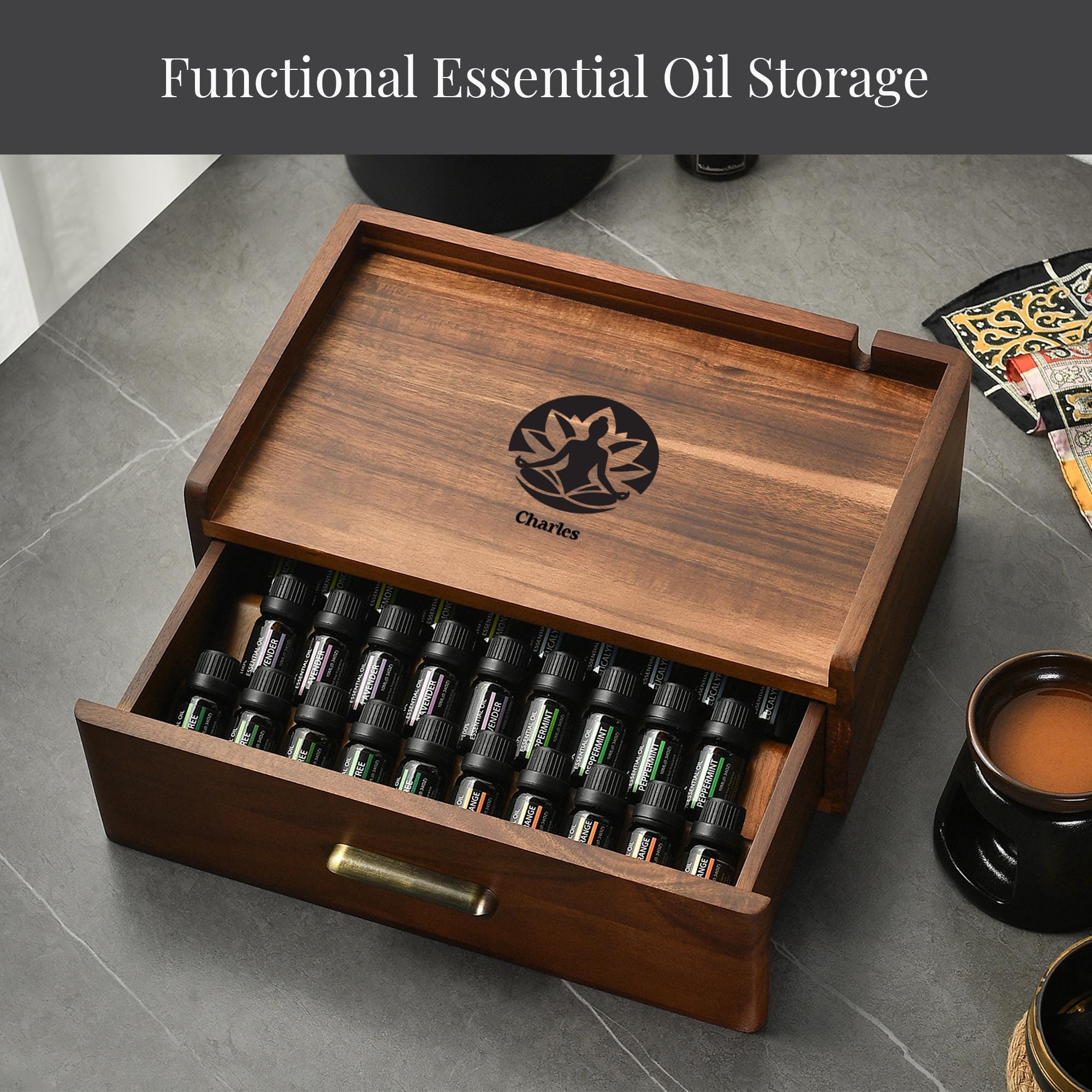 A wooden drawer with a lid, containing various bottles of essential oils, and a cup of what appears to be tea or coffee on the side.