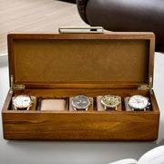 three watches in a wooden box on a table