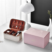 a pink box with jewelry inside of it