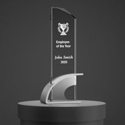 a glass trophy on a pedestal with a plaque