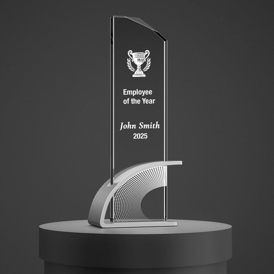 a glass trophy on a pedestal with a plaque