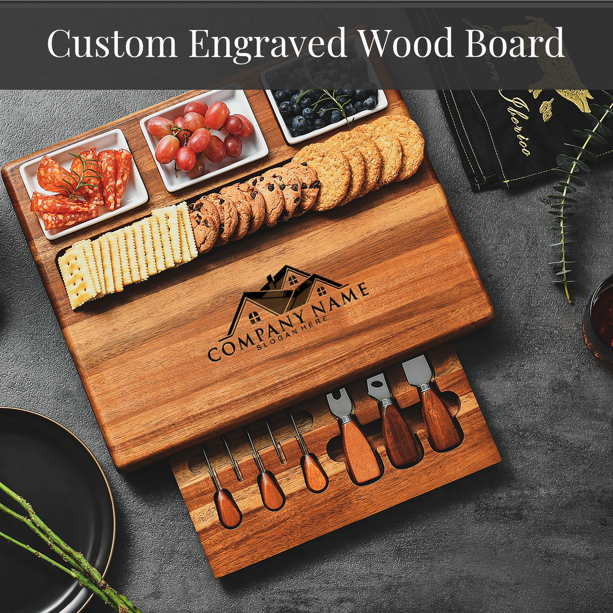 A wooden cutting board with various food items, including grapes, cookies, crackers, and cheese, as well as a set of wooden utensils.