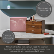 a wooden organizer with three drawers, a pink box, and a wooden box with a mirror, all placed on a marble table.
