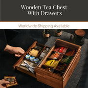 a wooden tea chest with drawers, containing various tea bags and other tea-related items. The chest is placed on a table, and there are two cups visible in the scene.