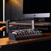 a wooden desk with a computer monitor and watch display