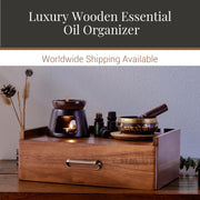 a wooden oil organizer with various items on top, including a bowl, a candle, and several bottles.