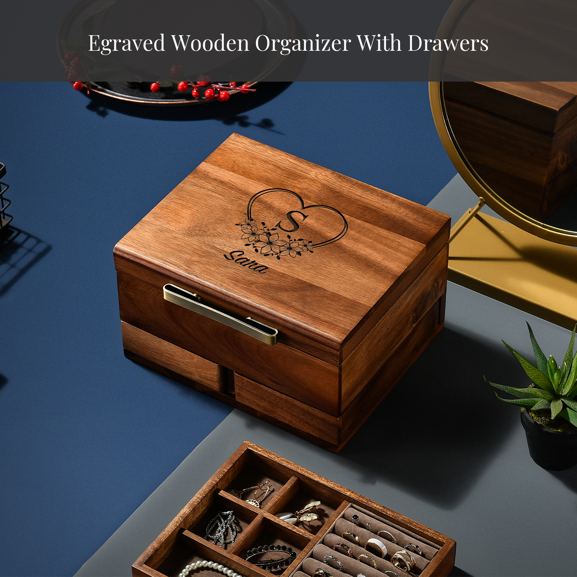 a wooden organizer with drawers, a potted plant, and a mirror on a blue surface.