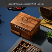 a wooden organizer with drawers, a potted plant, and a mirror on a blue surface.