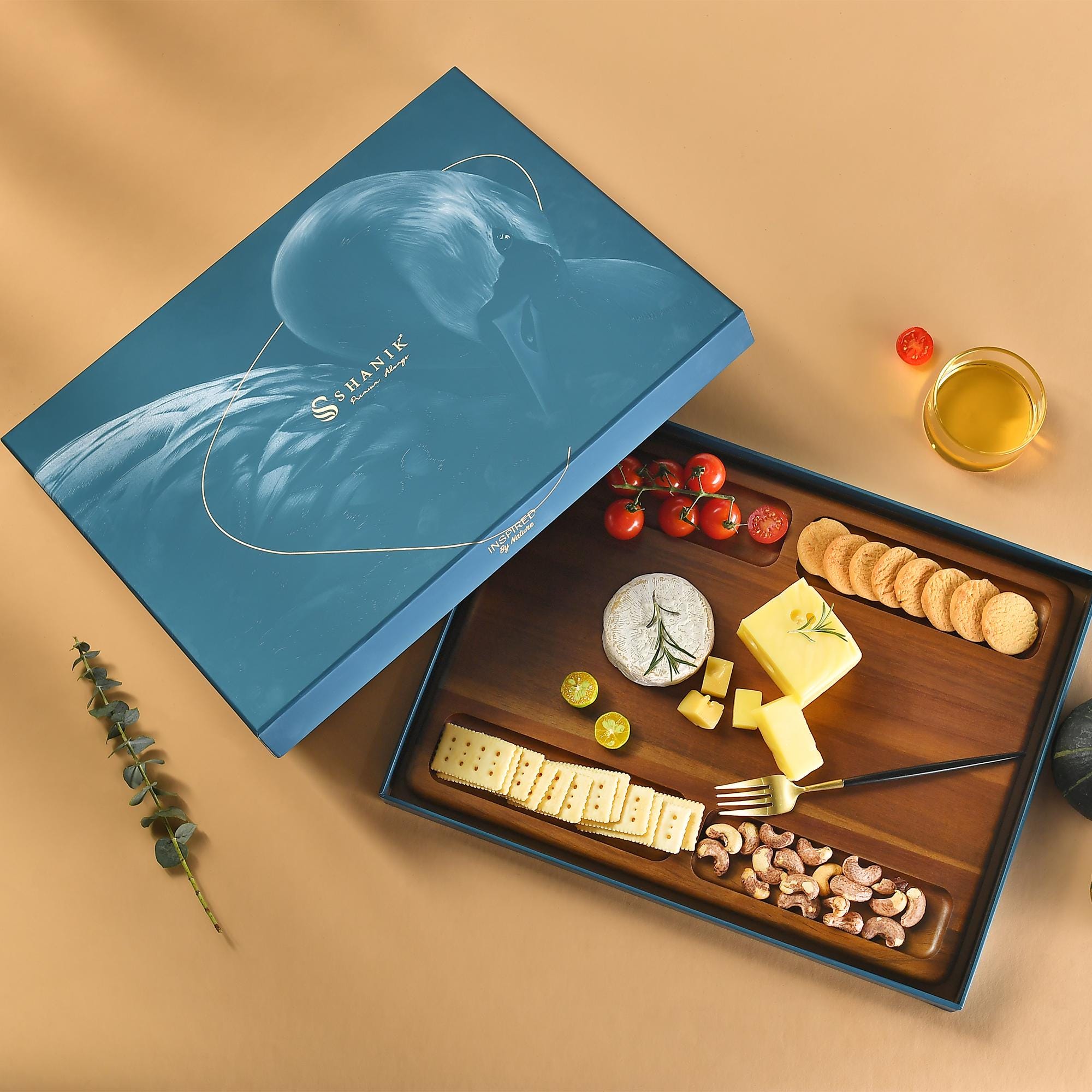 a wooden cutting board topped with cheese and crackers