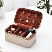 an open suitcase filled with jewelry sitting on a table
