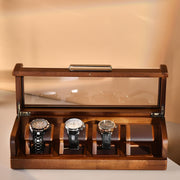 a wooden box with three watches inside of it