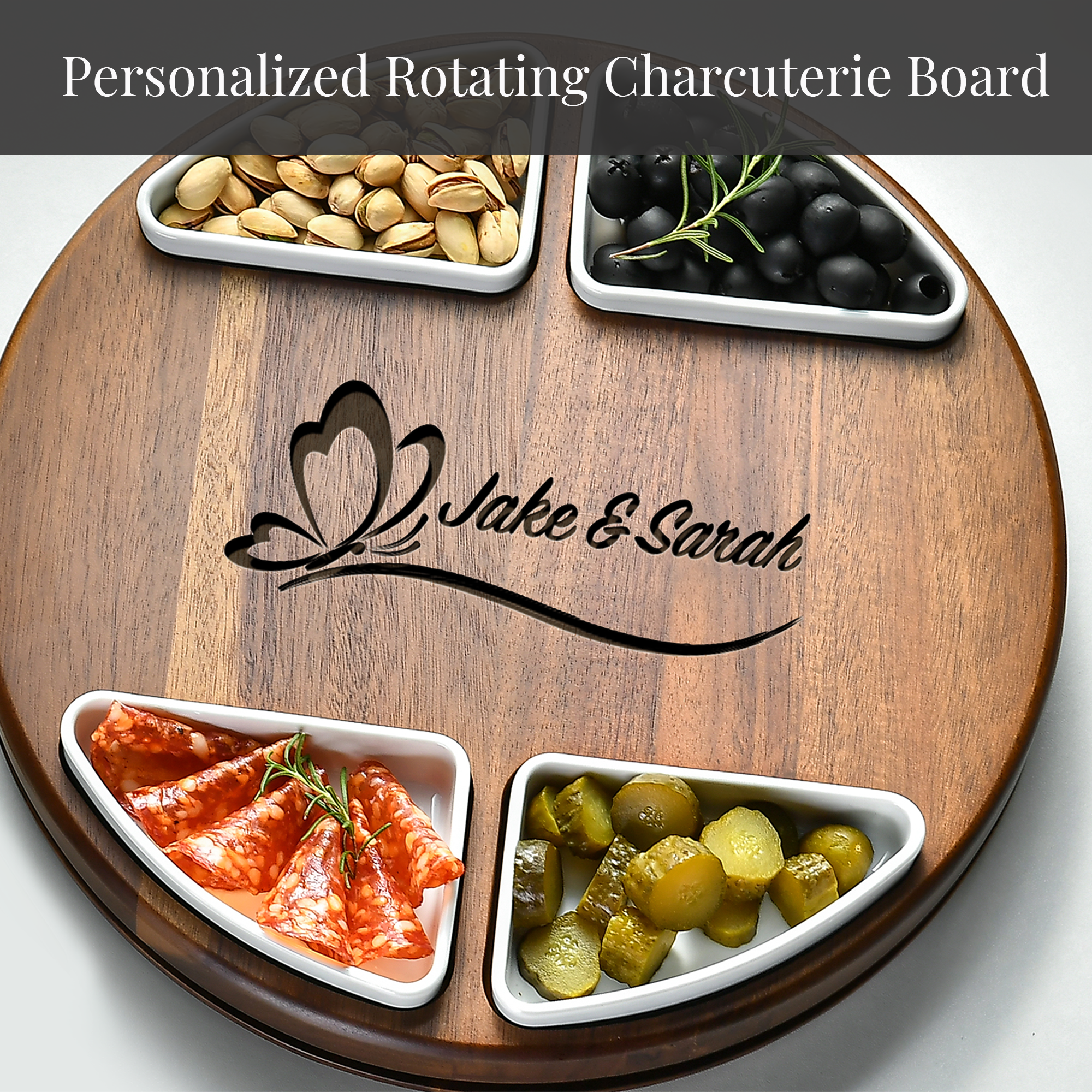 A wooden serving board with four compartments containing various types of food, including nuts, olives, pickles, and sliced meats.