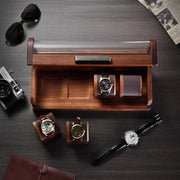 a wooden case with three watches and a watch on it