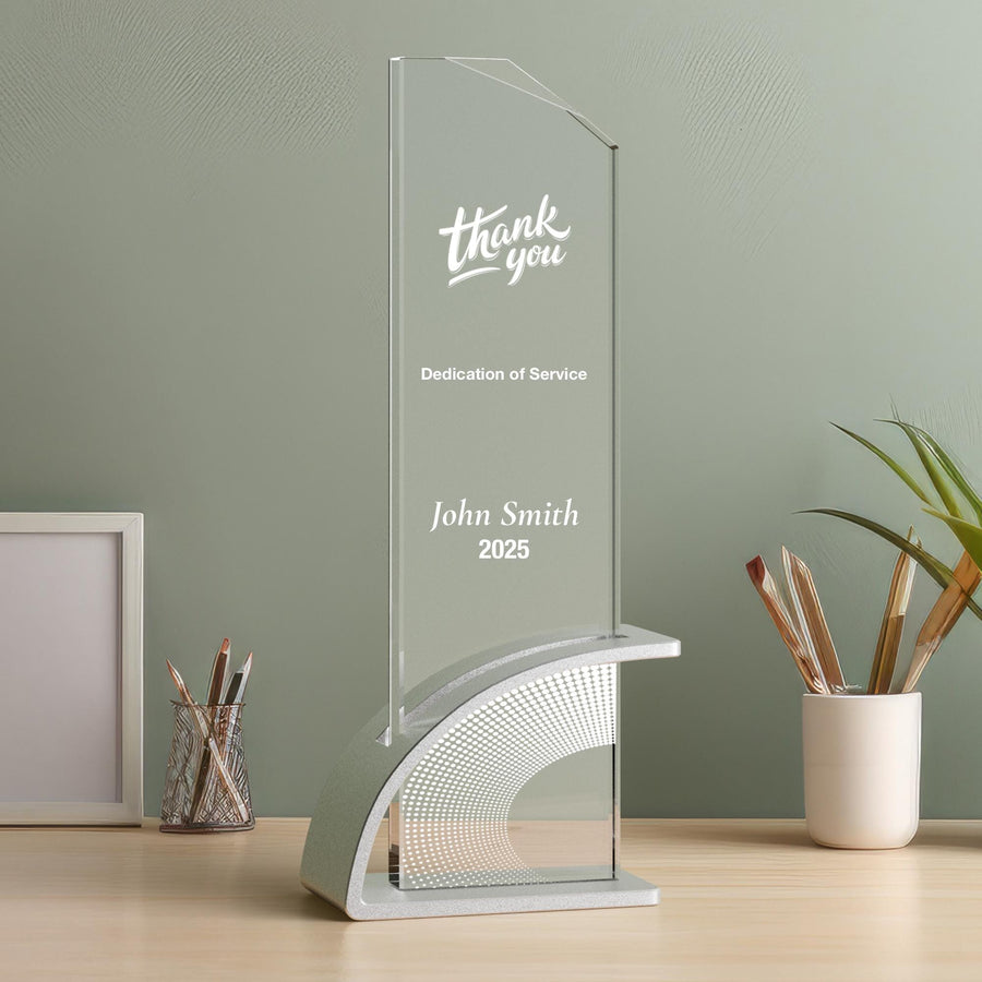 a clear glass award sitting on top of a wooden table
