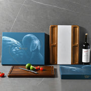 a bottle of wine and a cutting board with tomatoes and a knife