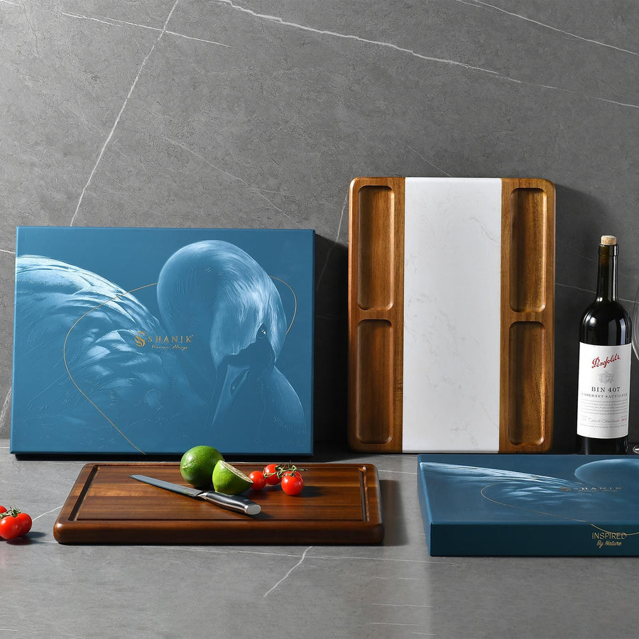 a bottle of wine and a cutting board with tomatoes and a knife
