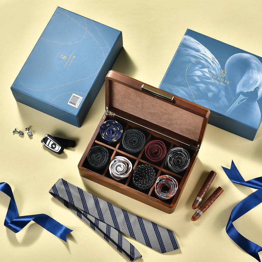 a box of ties and a tie bar on a table