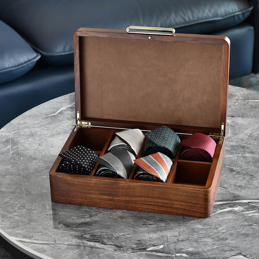 a wooden box filled with ties on top of a table