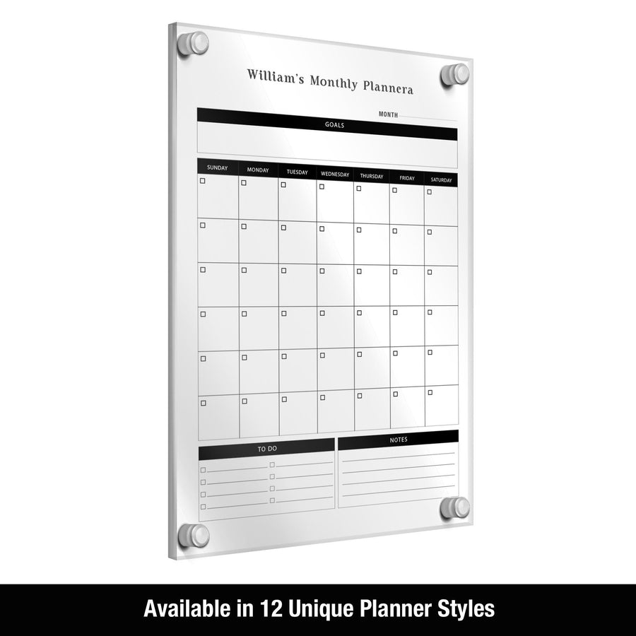 a wall-mounted, 12-style, monthly planner with a clear, white, and black design.
