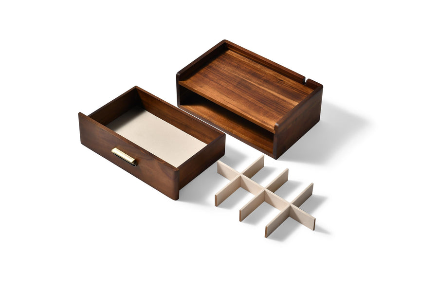 a wooden drawer with a white divider tray placed inside it.