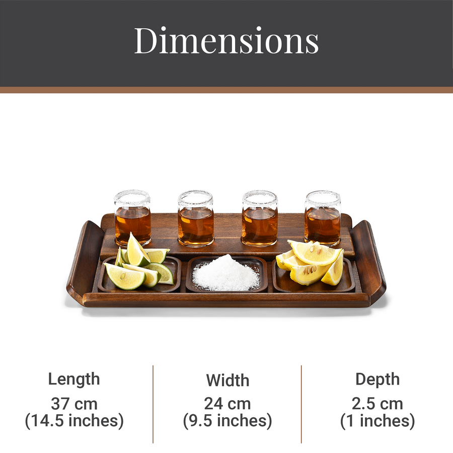 a wooden tray with four shot glasses filled with a brown liquid, along with sliced lemons and a pile of sugar. The tray is placed on a white surface.