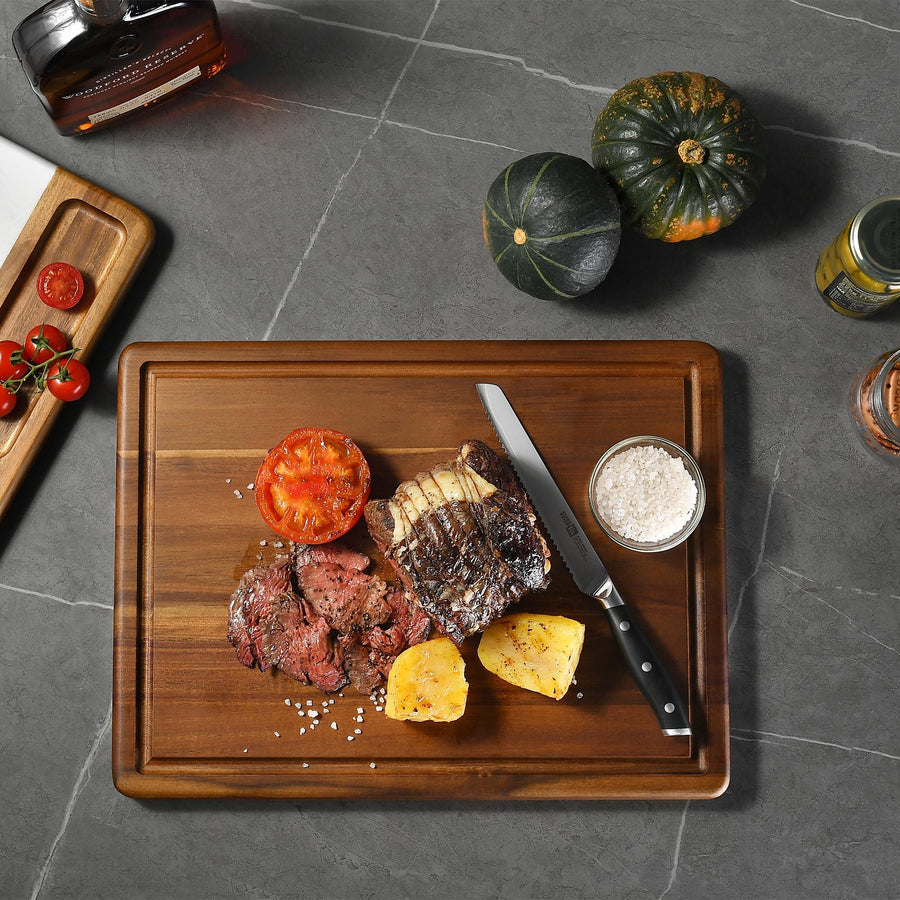 a wooden cutting board topped with meat and vegetables