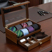 A wooden tie case with multiple compartments, displaying a variety of colorful ties neatly arranged inside.