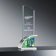 Happy Retirement award for Susan Thompson, 2024, crafted from optic crystal with a vibrant abstract pattern base, showcased on a reflective surface.
