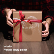 a person holding a brown box with a red ribbon