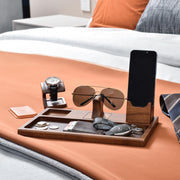 a wooden tray with sunglasses, a cell phone and a pair of sunglasses on it