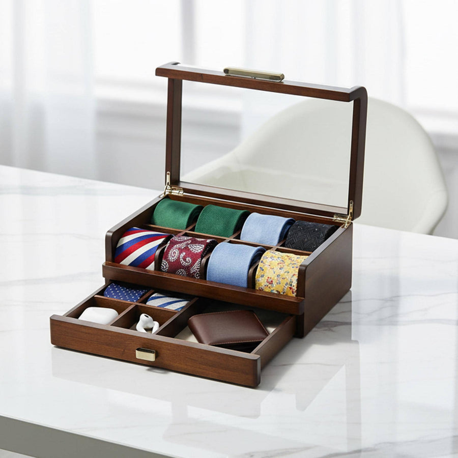 A wooden tie holder with multiple compartments, displaying a variety of colorful ties, is placed on a white marble surface.