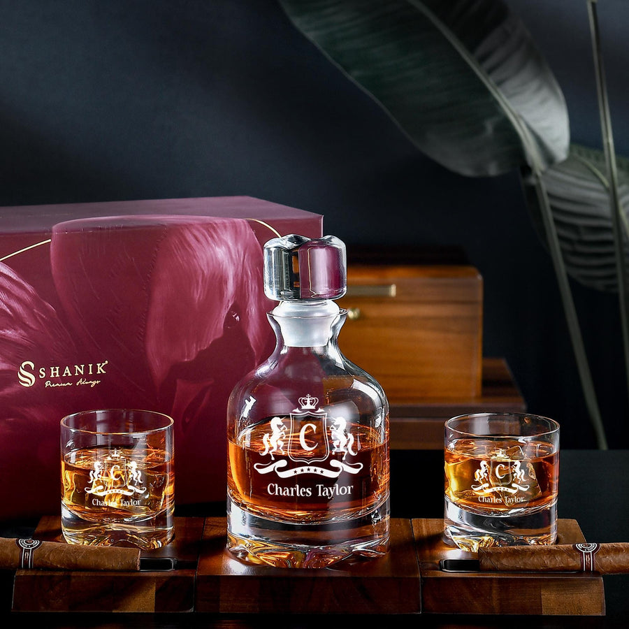 a bottle of whisky sitting next to two glasses