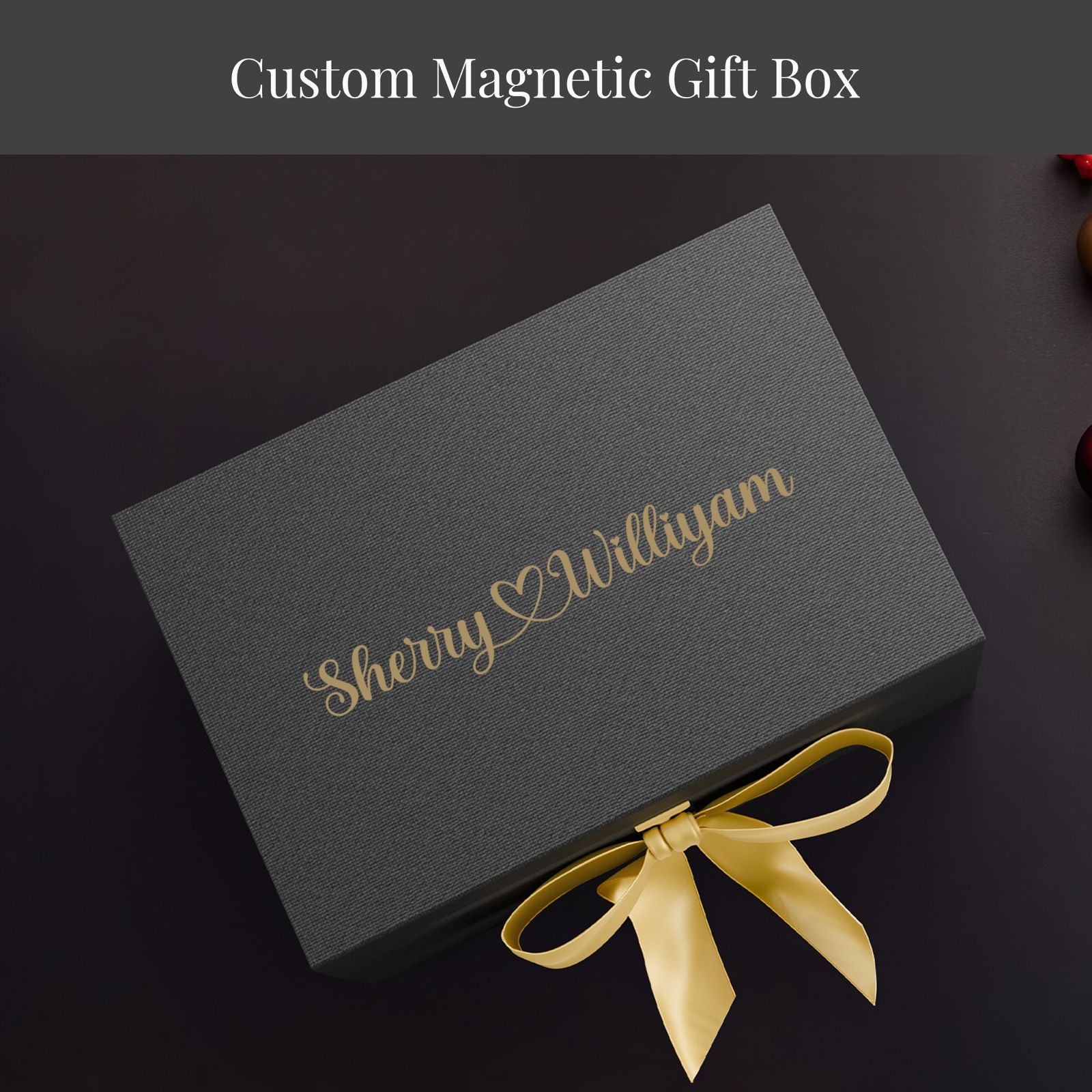 A gray gift box with a gold ribbon tied around it, placed on a dark surface.